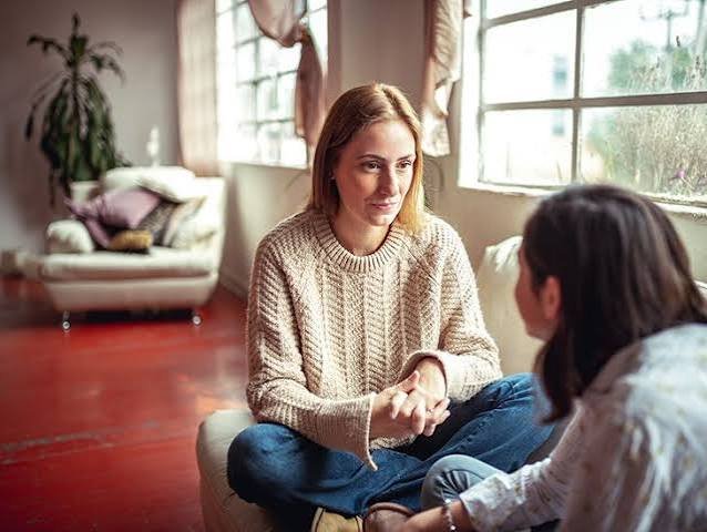 Anxiety and depression therapy: two women having a supportive conversation